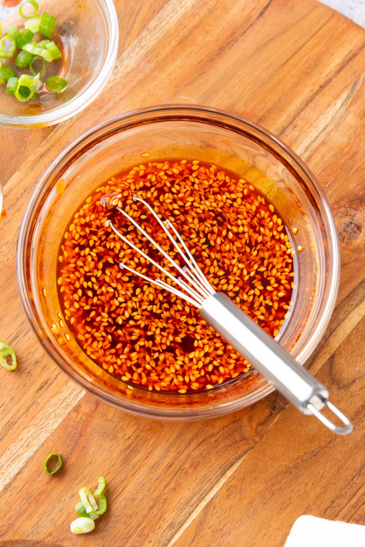 A whisk sitting in a bowl of this dumpling dipping sauce.