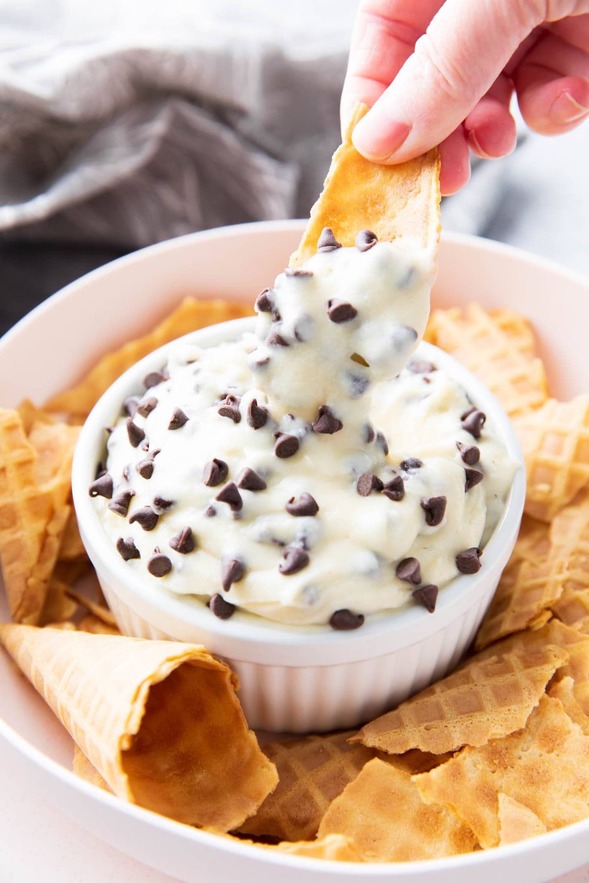 Someone scooping this easy cannoli dip recipe.
