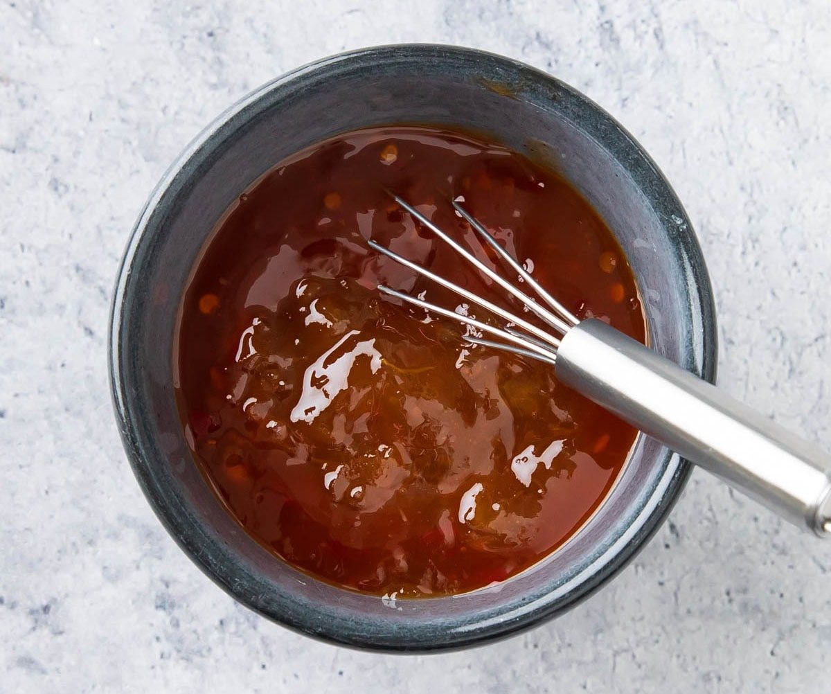 Whisking together sweet chili and apricot jam to make the dipping sauce.