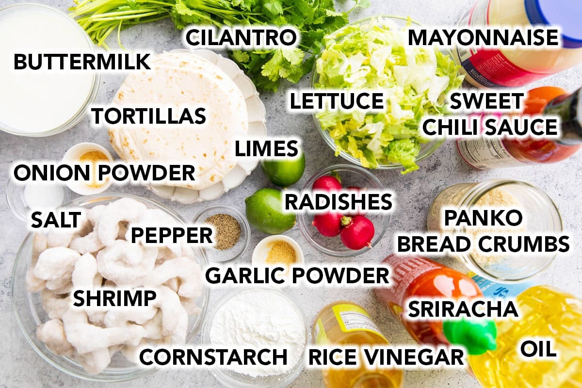 Bang Bang Shrimp Tacos recipe ingredients including bang bang sauce, buttermilk, shrimp, panko bread crumbs and seasonings, oil, taco-sized tortillas, shredded lettuce, radishes, fresh limes, and cilantro leaves