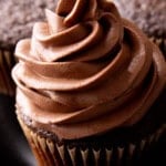 close up of creamy chocolate frosting on top of a cupcake