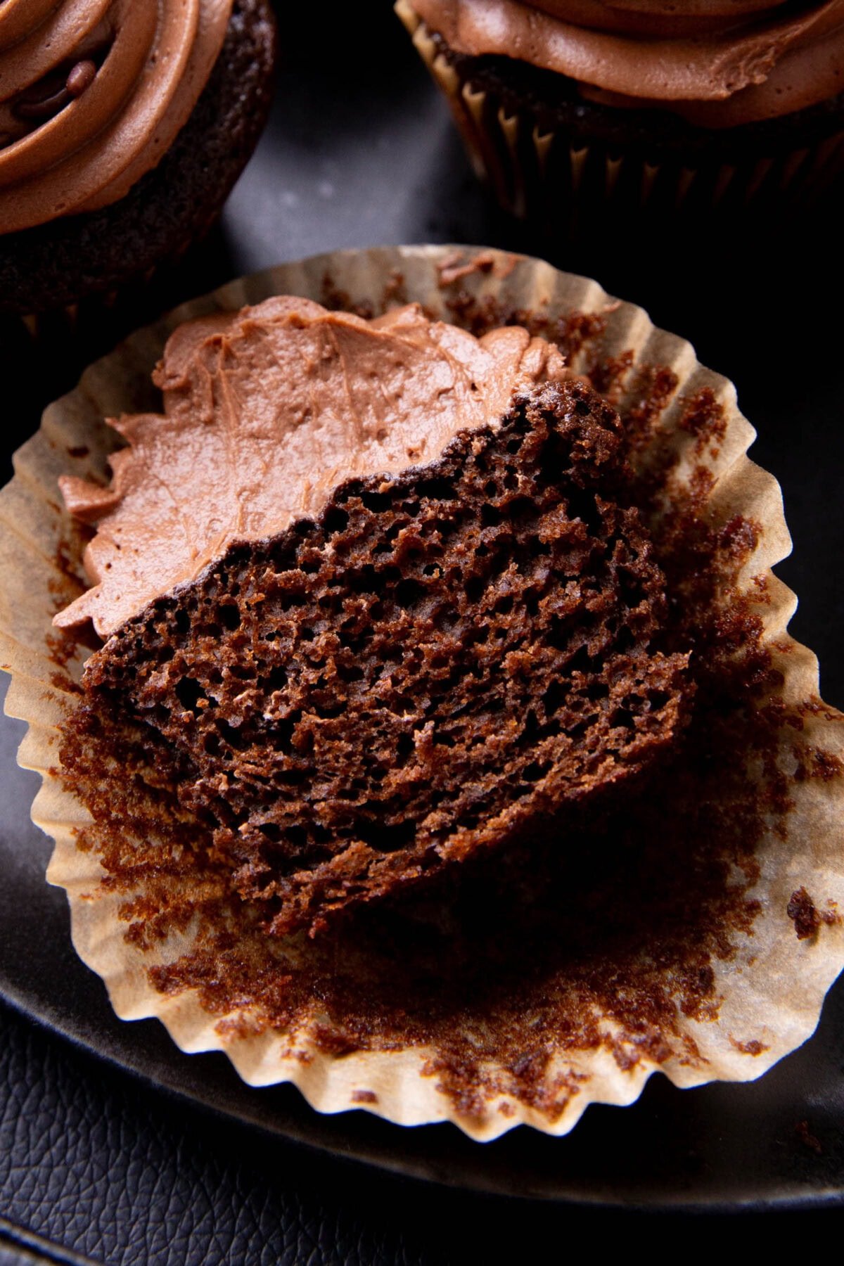 Easy chocolate cupcake cut in half to reveal moist, delicate and fudgy crumb