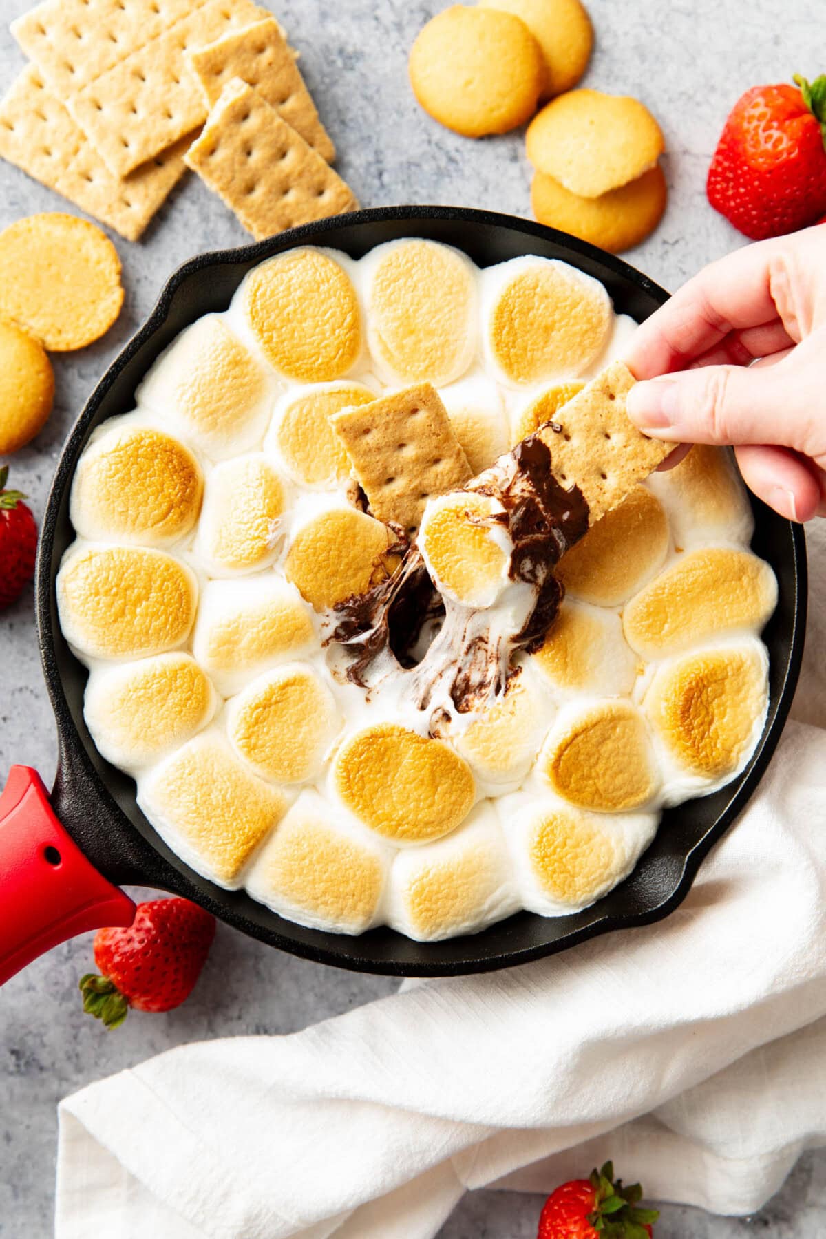 Two graham crackers dipped into this dessert-inspired, campfire summer S'mores dip.