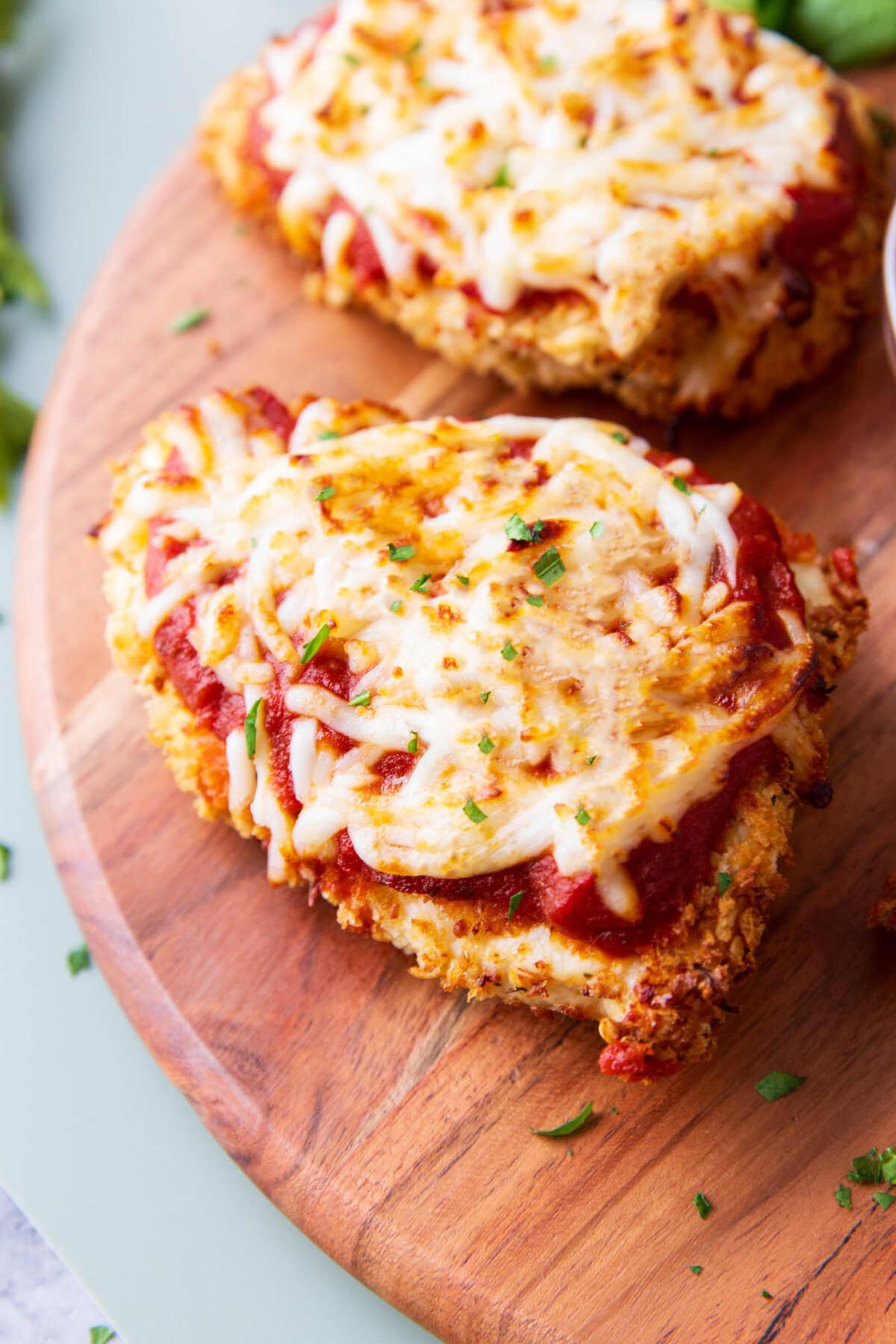 close up of air fryer chicken parmesan with melty mozzarella and loads of marinara on top