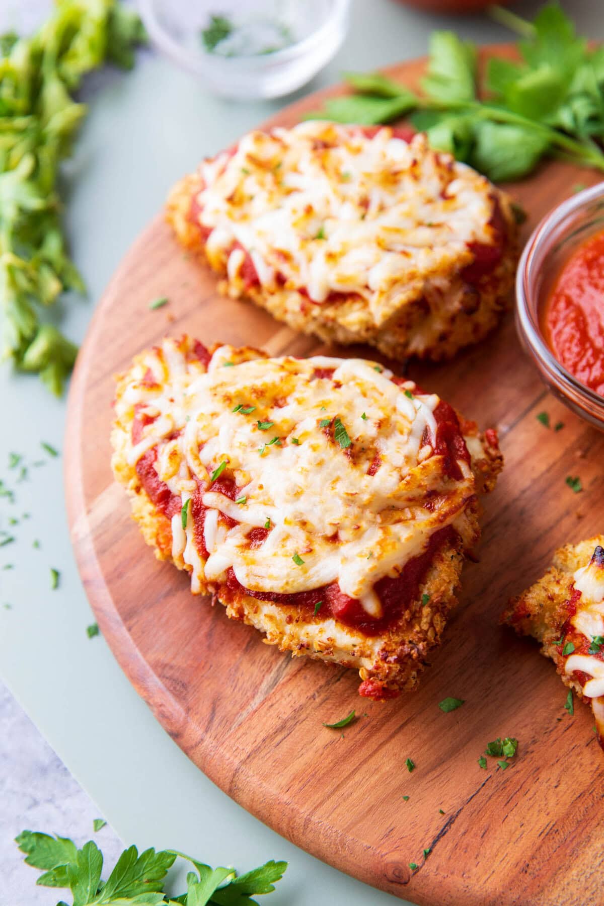 Melted mozzarella and tangy marinara top crispy breaded chicken parmesan made in air fryer