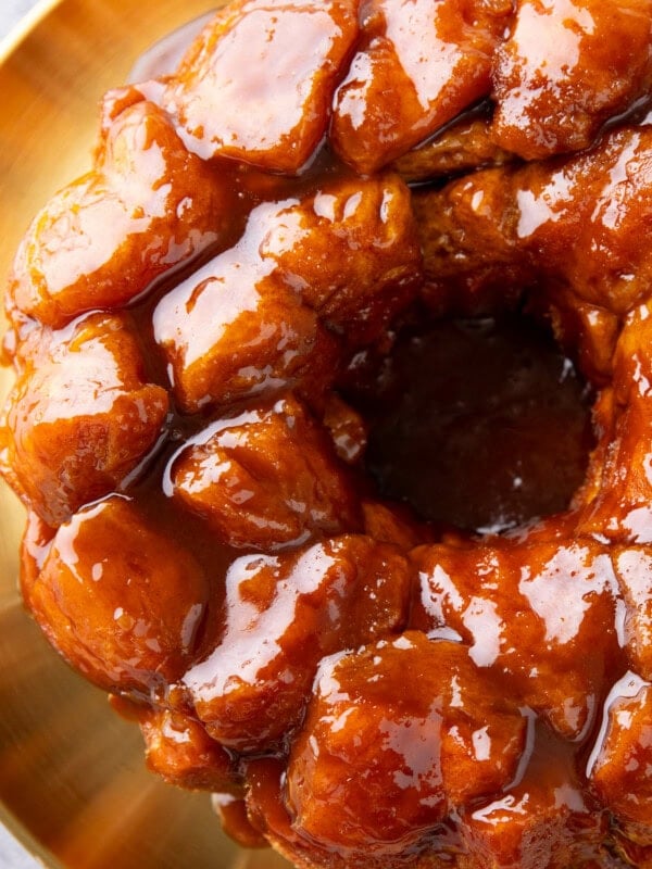 overhead photo of monkey bread to show the sticky glaze coating a ring of cinnamon sugar pullapart biscuit pieces