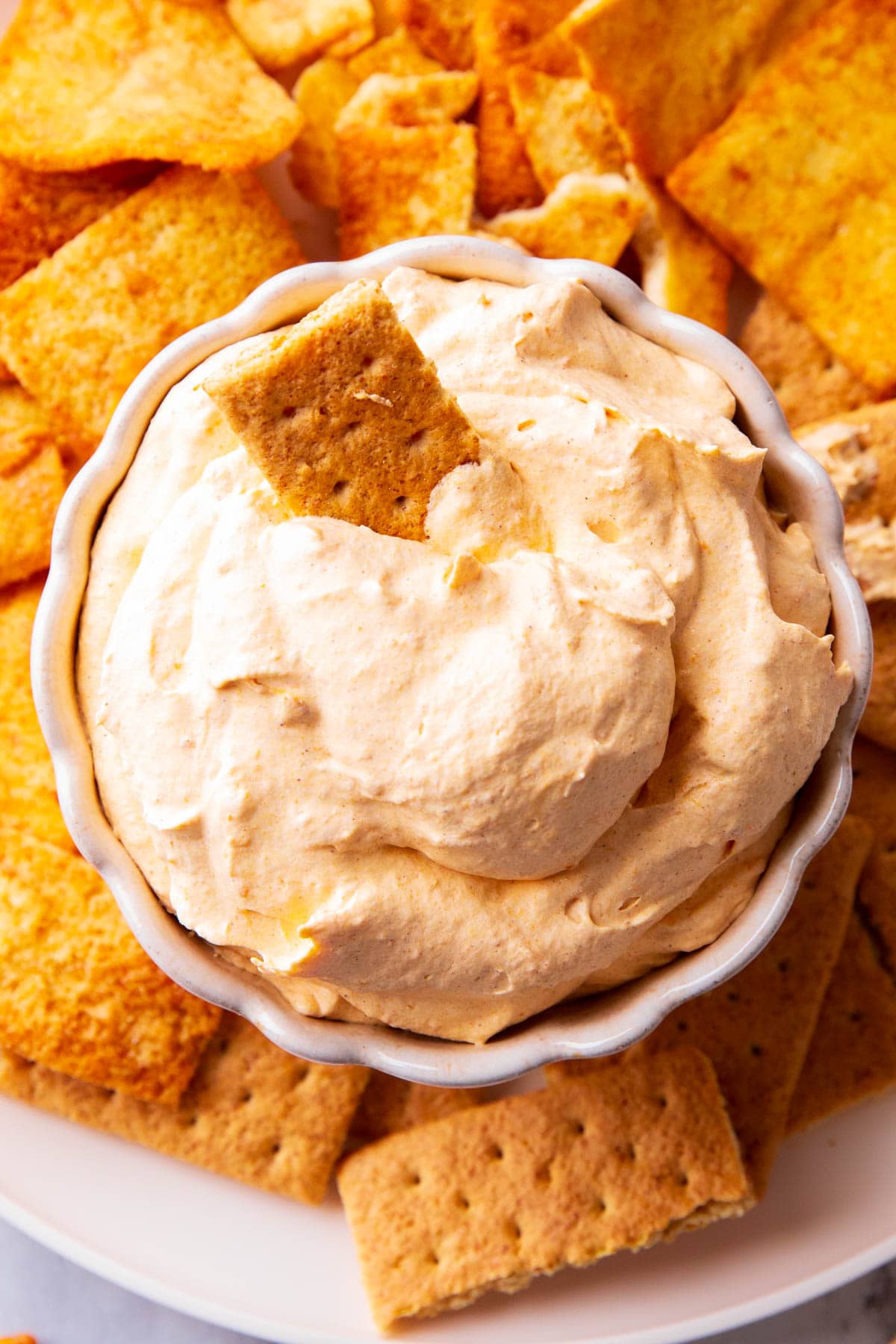 No bake pumpkin fluff with Cool Whip served in a bowl for easy dipping.