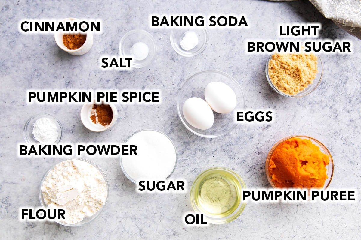 Pumpkin Cupcakes ingredients measured into prep bowls including pumpkin puree, eggs, oil, brown sugar, cane sugar, baking soda, flour, salt, and vanilla