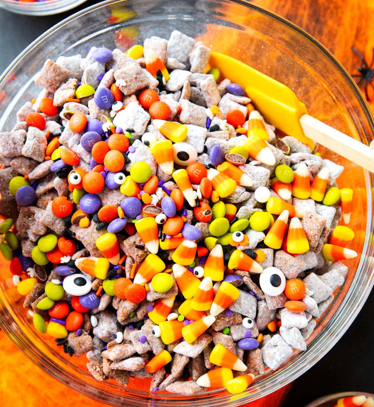 Stirring together the ingredients to show how to make Halloween puppy chow.