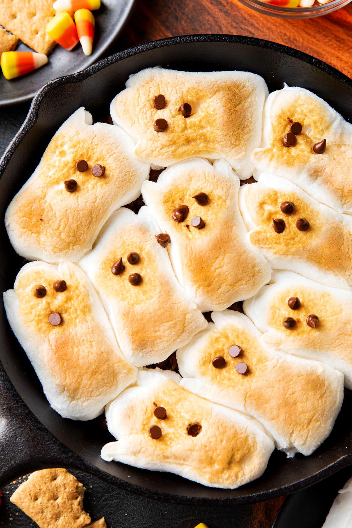 Ghost-shaped toasted marshmallows sit atop melted chocolate in this Halloween-ready appetizer dessert dip.