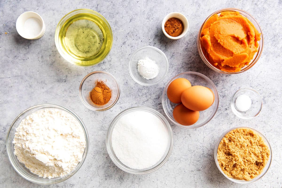 Pumpkin Cake with cream cheese frosting ingredients include flour, pumpkin, oil, sugar, brown sugar, pumpkin pie spice, cinnamon, and more.