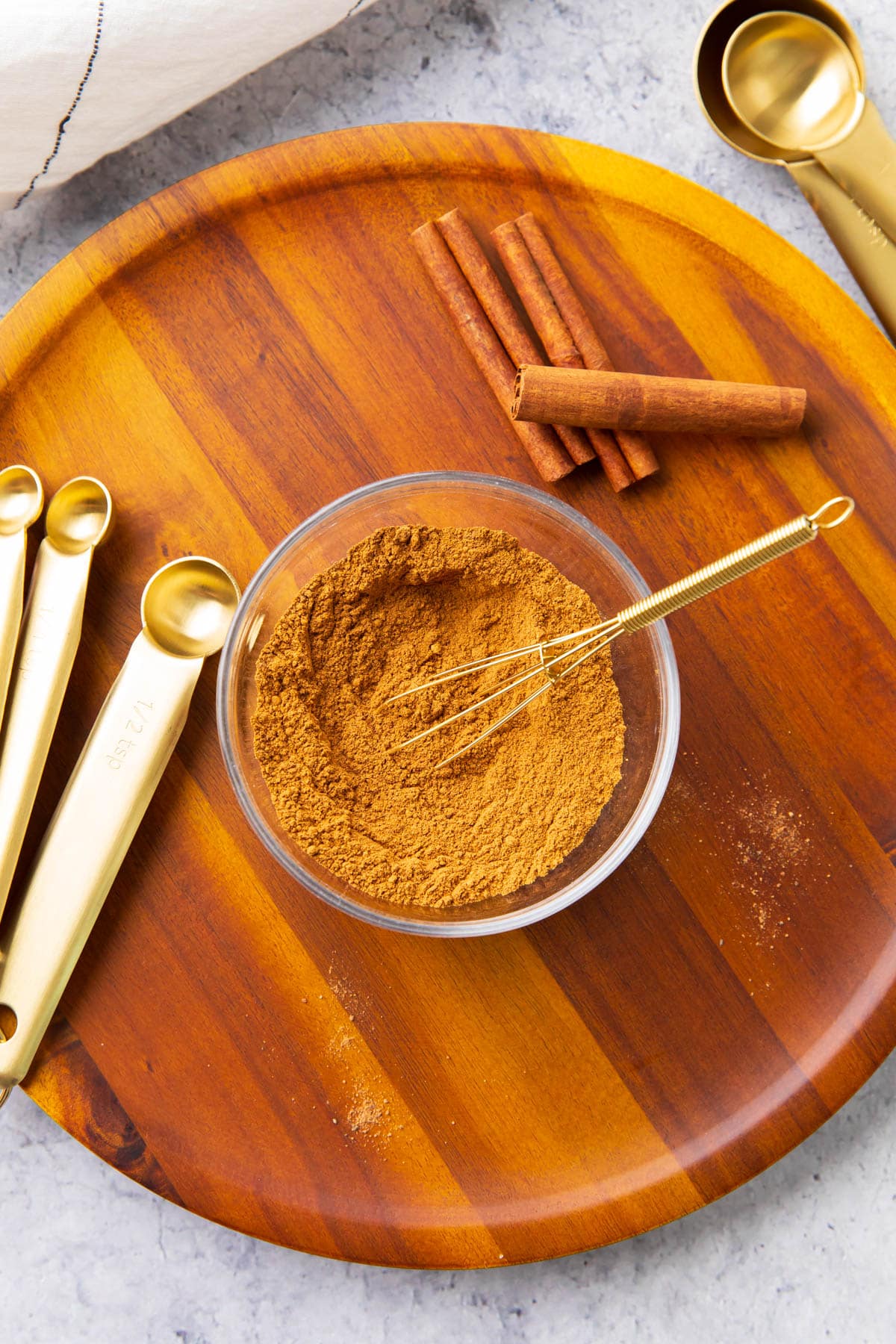 A photo showing how to make homemade pumpkin pie spice recipe - all spices are whisked together thoroughly.