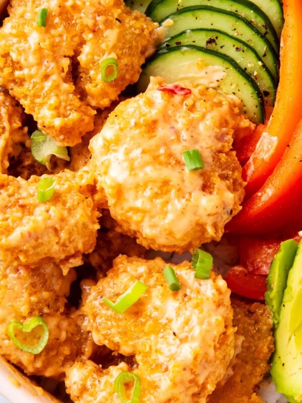 Close up of bang bang shrimp recipe easy shows crisp fried shrimp coated in bang bang sauce.