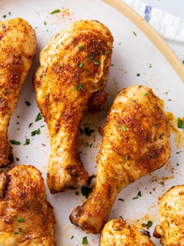 Close up of Cajun chicken drumsticks show golden skin coated with Cajun seasoning