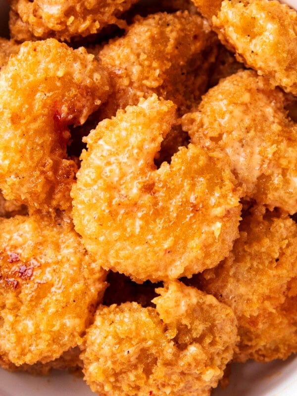 close up of easy bang bang shrimp shows crisp fried shrimp coated in bang bang sauce