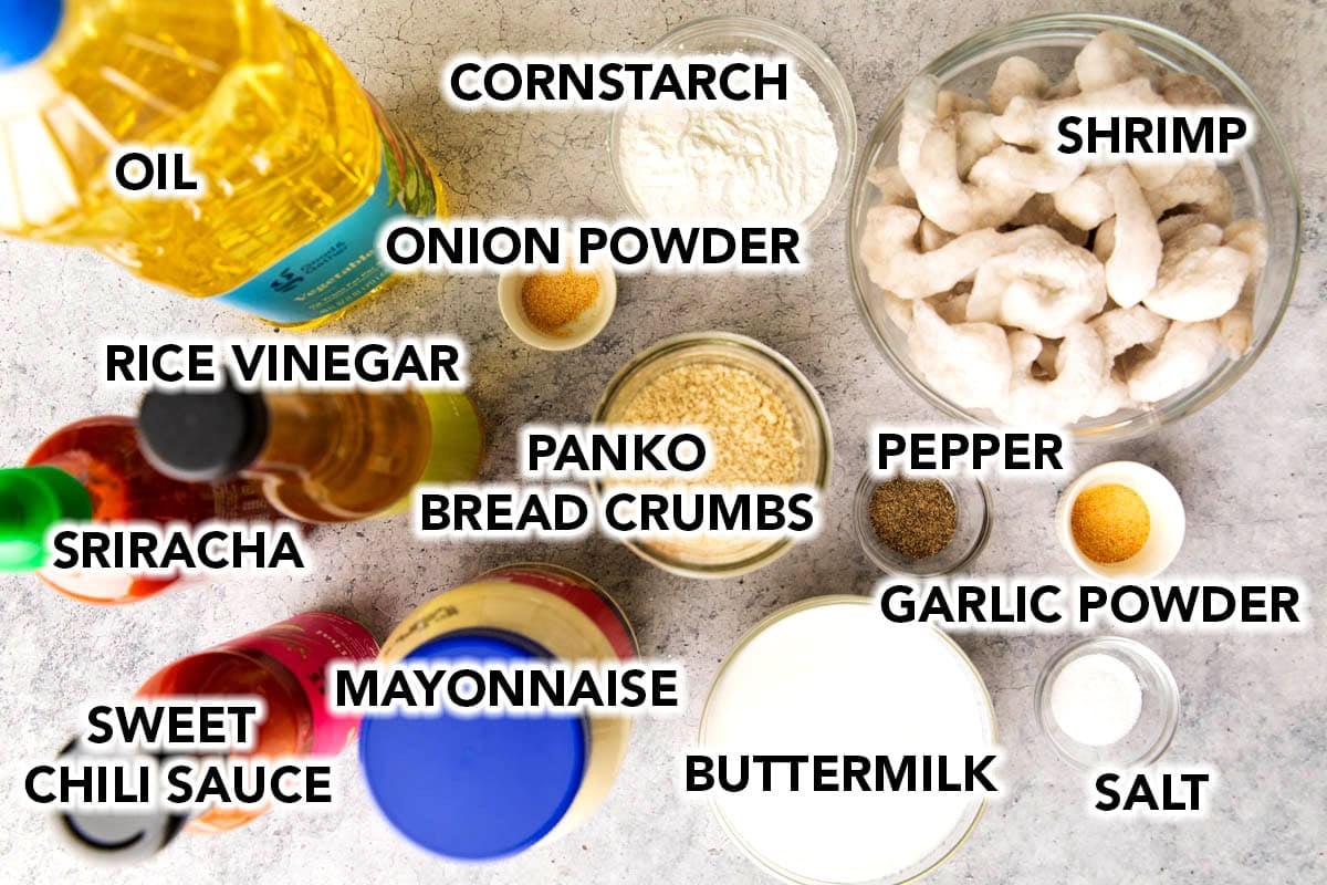 Copycat bang bang shrimp ingredients in prep bowls - mayonnaise, thai sweet chili sauce, sriracha, rice vinegar, shrimp, buttermilk, Panko and more.