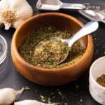 close up of garlic and herb seasoning in a spice bowl