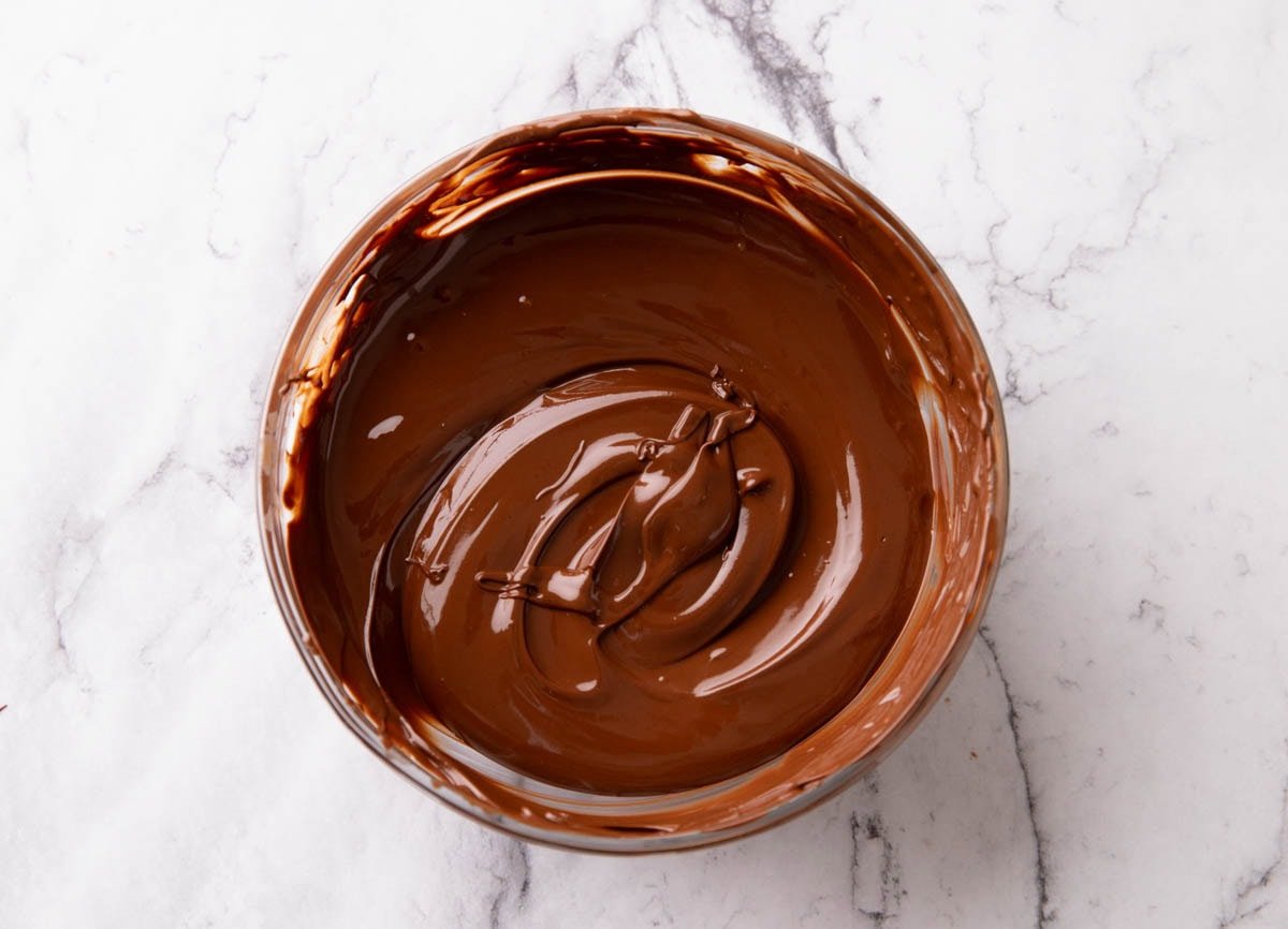 Melted chocolate in a bowl for preparing Halloween Bark candy recipe