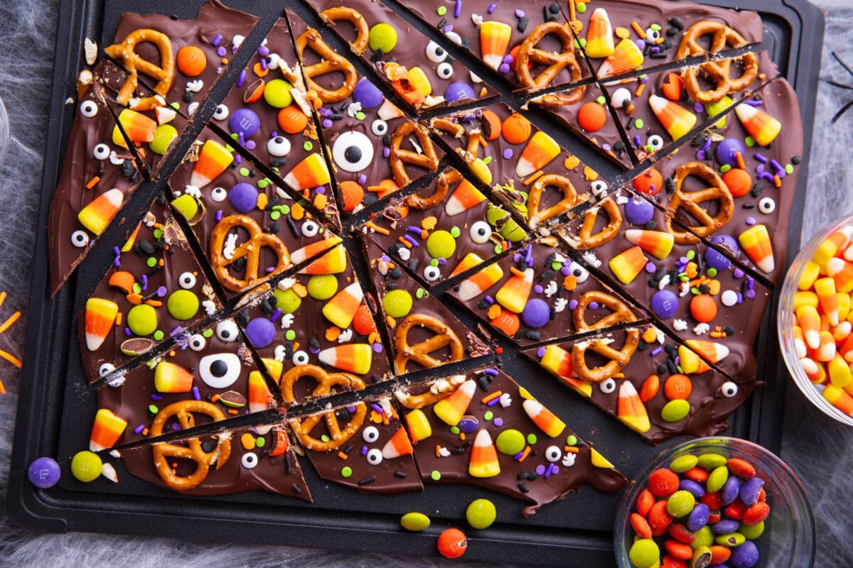A photo showing How to Make this easy chocolate candy - slicing candy corn, pretzels, and more into pieces
