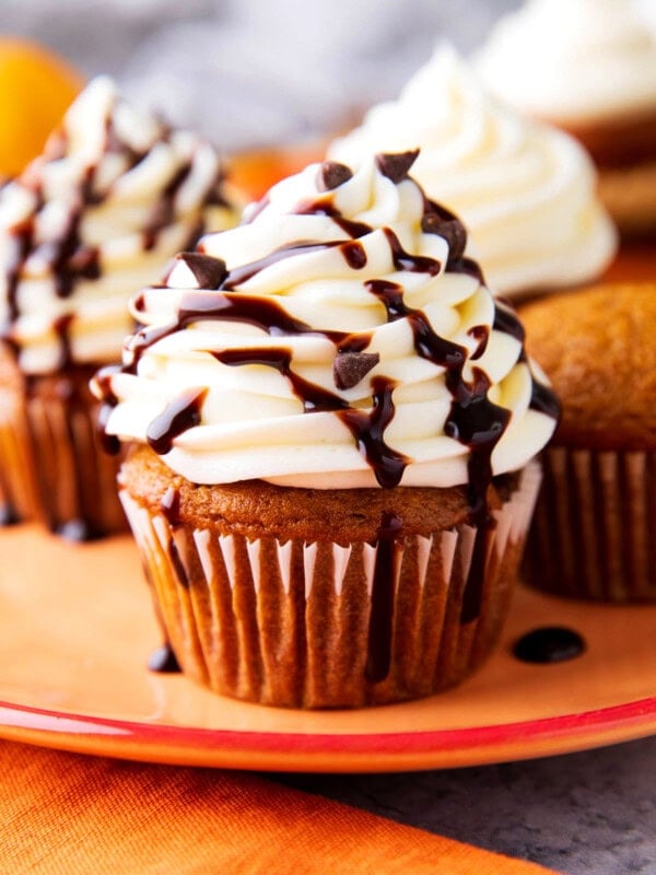pumpkin chocolate chip cupcakes are moist and topped with cream cheese frosting with chocolate chips and chocolate drizzle