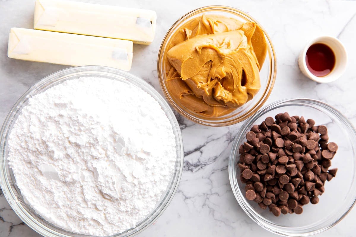 Buckeye Balls recipe ingredients are old fashioned, including sticks of butter, peanut butter, powdered sugar, vanilla, and chocolate chips.