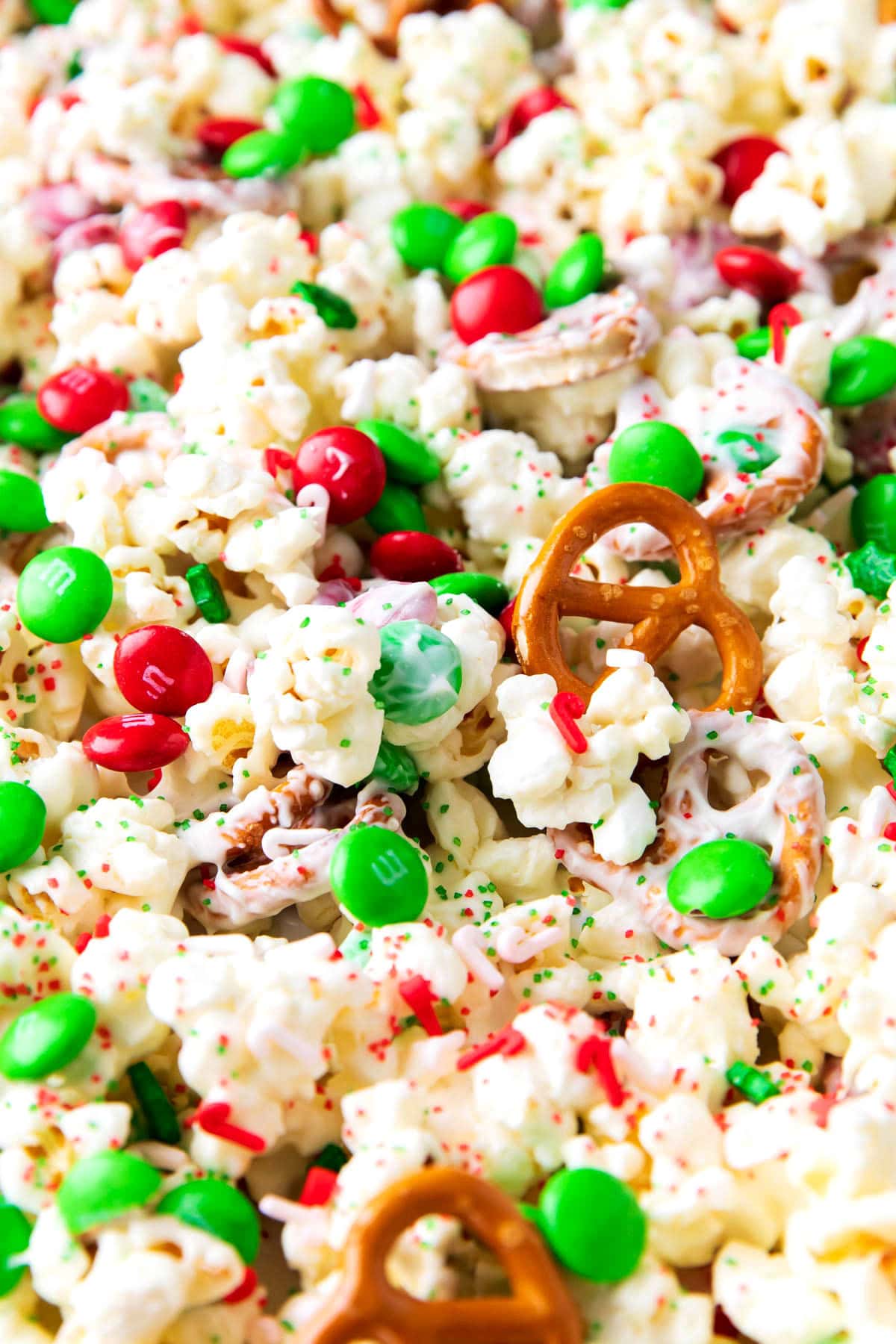 White chocolate popcorn - Christmas recipe included crunchy pretzels, buttery popcorn, candy, and sprinkles for an easy treat to gift during the holidays.