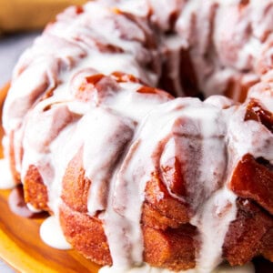 Easy Cinnamon Roll Monkey Bread with cinnamon roll pieces coated in brown sugar glaze is drenched in icing