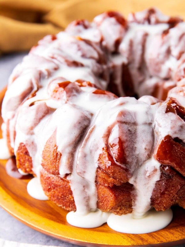 Easy Cinnamon Roll Monkey Bread with cinnamon roll pieces coated in brown sugar glaze is drenched in icing