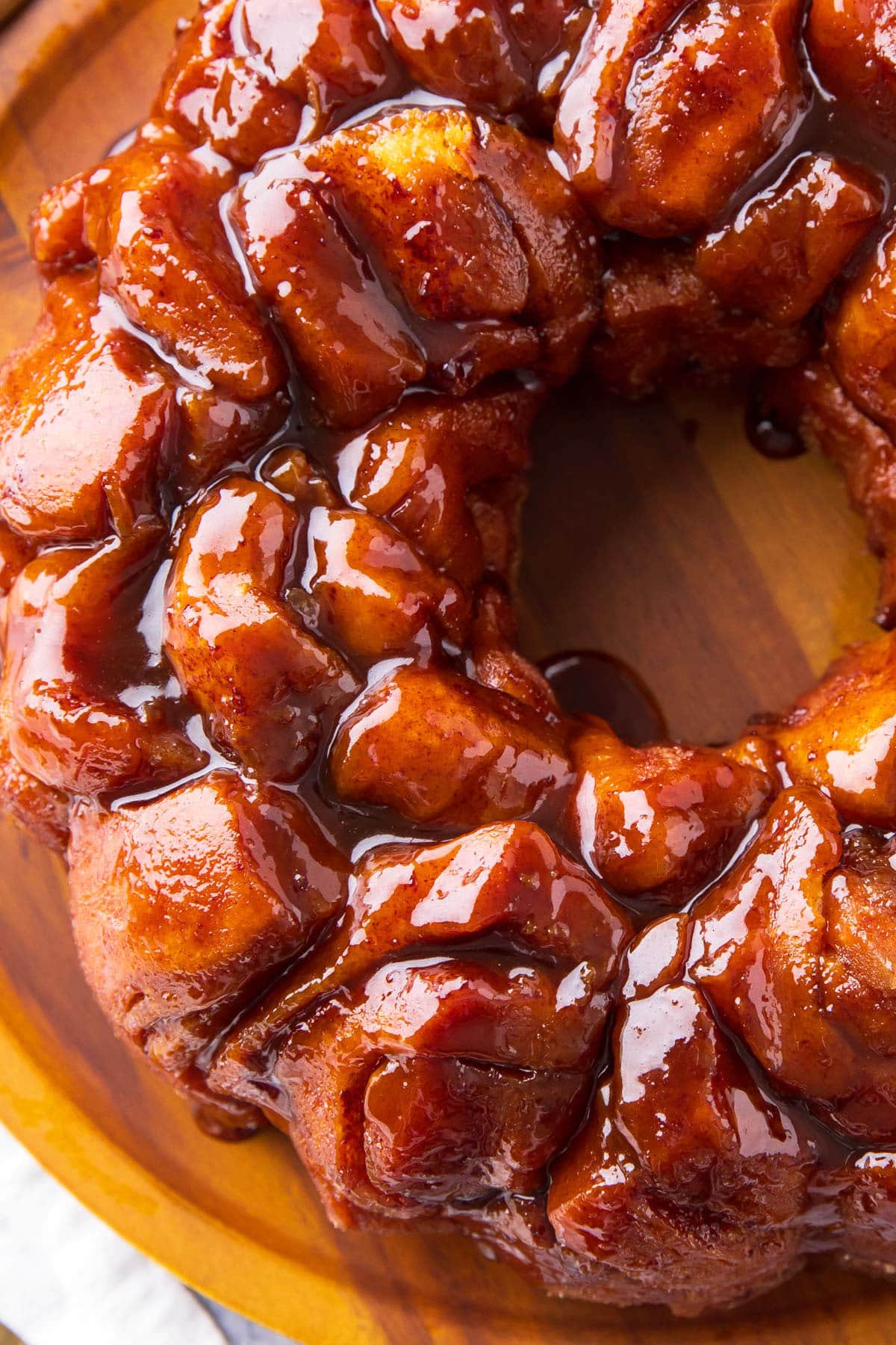 Overhead photo of Cinnamon Roll Monkey Bread served on a platter with pillowy cinnamon roll pieces held together with a glaze.
