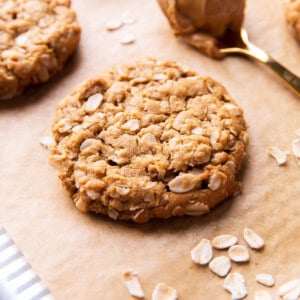 peanut butter oatmeal cookies with crisp edges and chewy oatmeal-packed centers on parchment paper