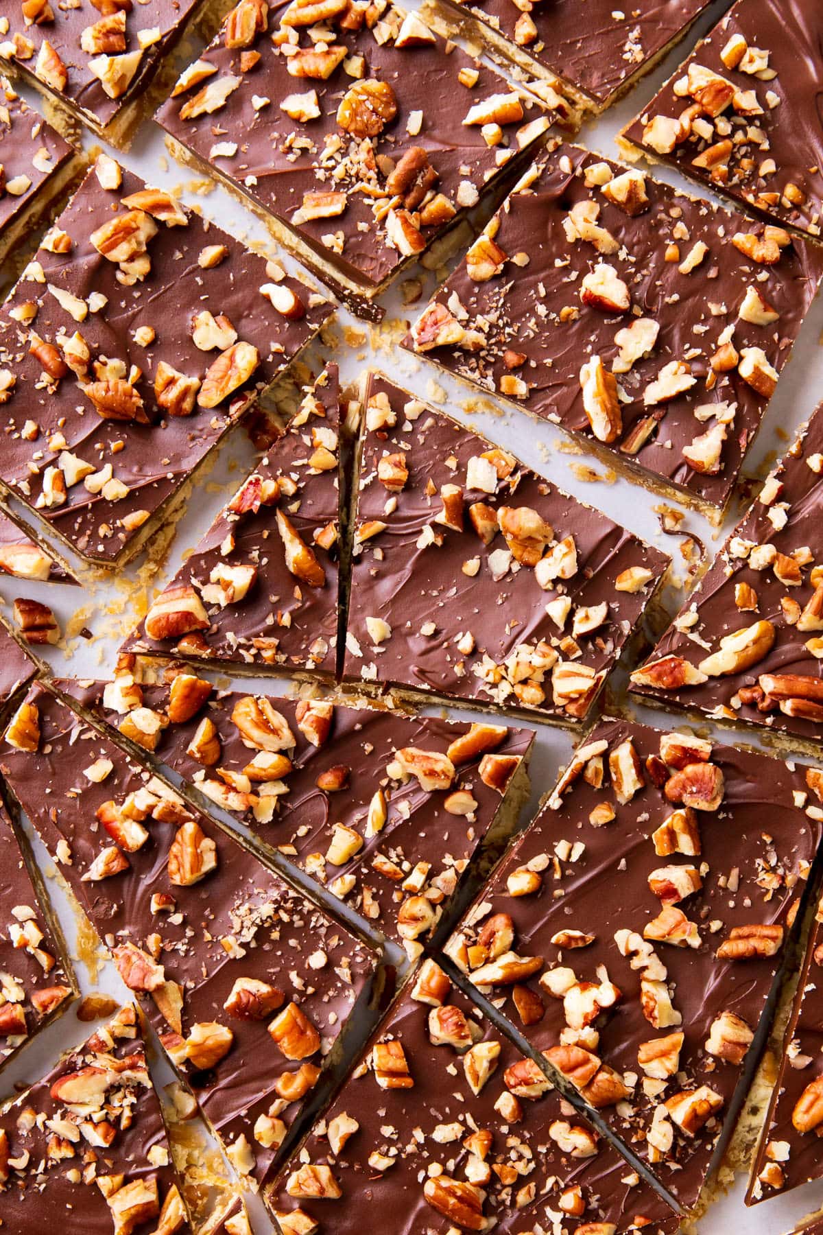 Saltine Cracker Toffee candy recipe has a layer of chocolate and pecans over saltine crackers covered in toffee.