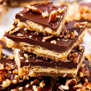 close up stack of Saltine Cracker Toffee shows the toffee covered cracker and chocolate pecan layers of this homemade candy