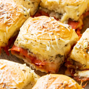 Fresh-baked pepperoni pizza sliders with Hawaiian rolls are packed with mozzarella cheese, pizza sauce, and garlic for an easy game day appetizer