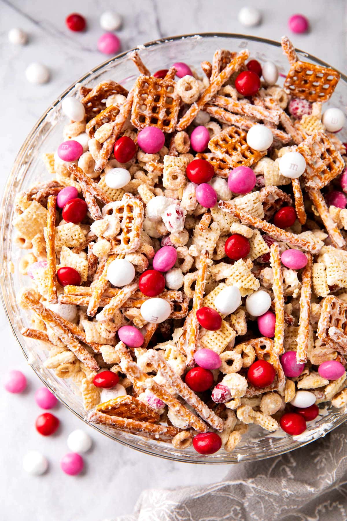 Valentine's Chex Mix is white candy coated Chex mix, cereal, pretzel and peanuts for a salty and sweet snack.