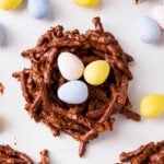 Close up of recipe for bird nests cookies shows chocolate and peanut butter chip coated chow mein noodles with Easter mini eggs