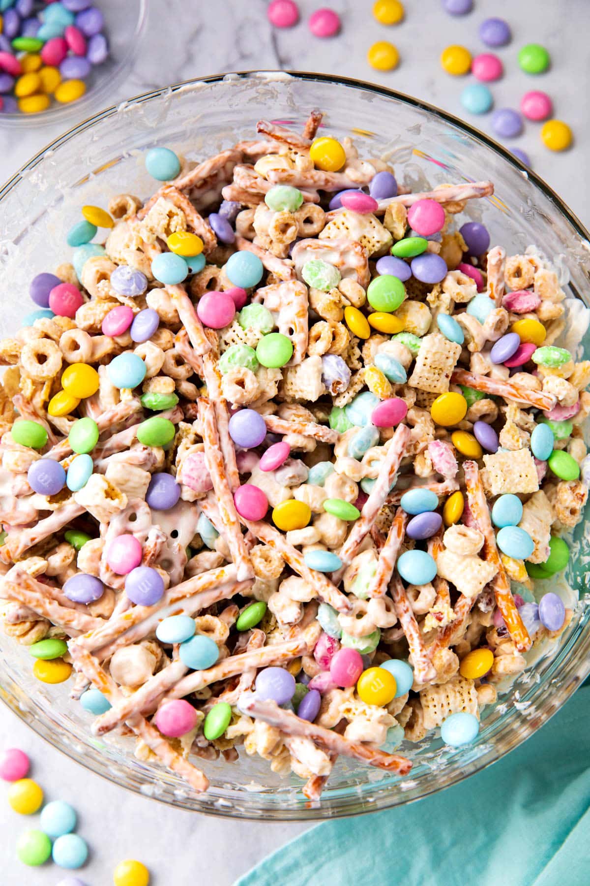 Bunny Bait recipe served in a bowl filled with Easter candies, Chex mix, pretzels, peanuts, and more.