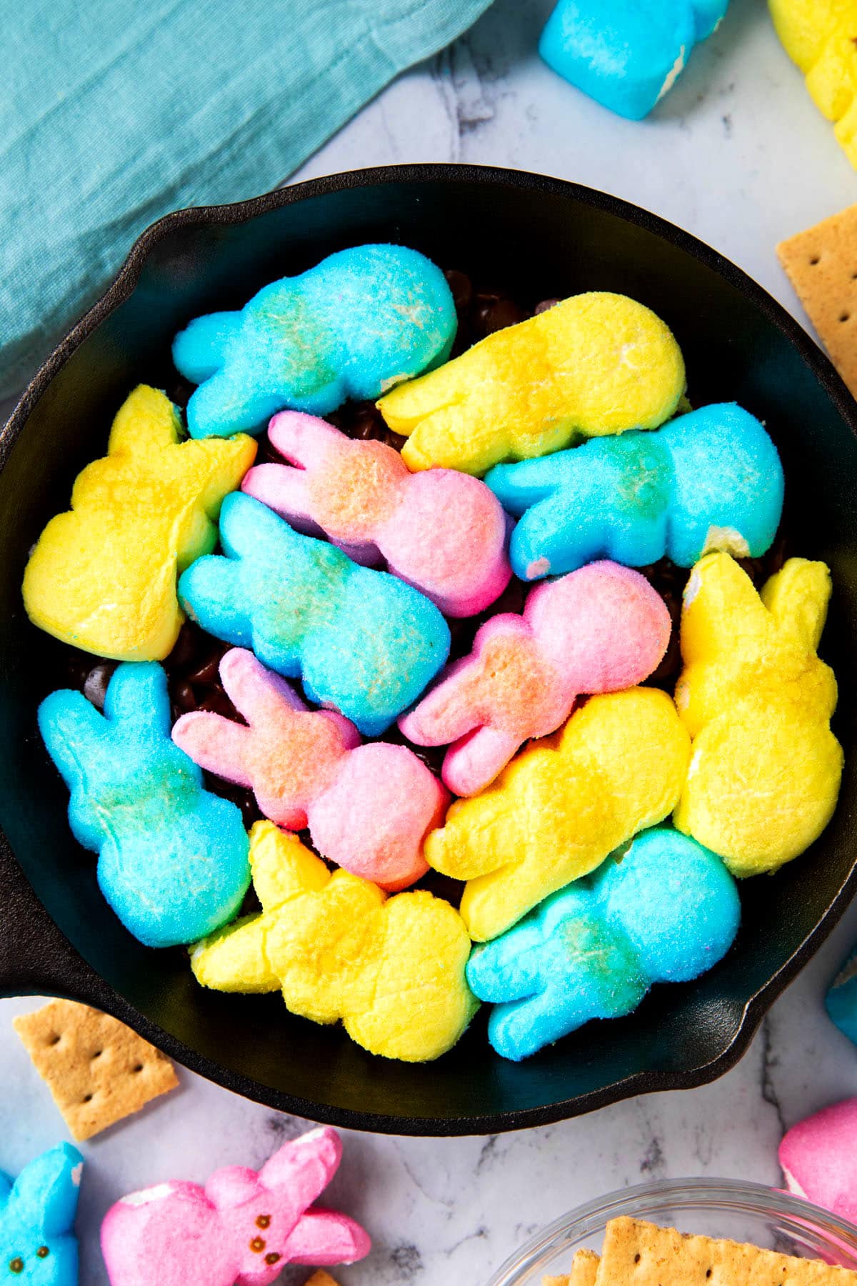 Overhead shot of Peeps S'mores Dip shows bunny Peeps marshmallows toasted in an oven skillet.