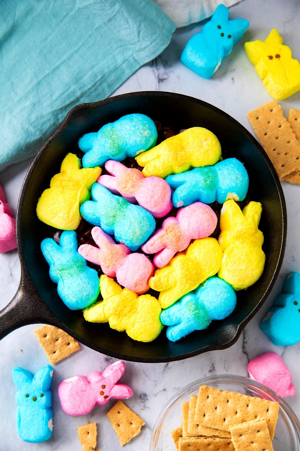 A photo showing how to tightly pack Easter marshmallows in the topping for this Easter dip.