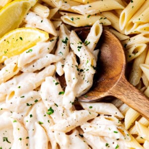 Scooping up Alfredo Penne Pasta loaded with bouncy pasta and lots of homemade Alfredo sauce