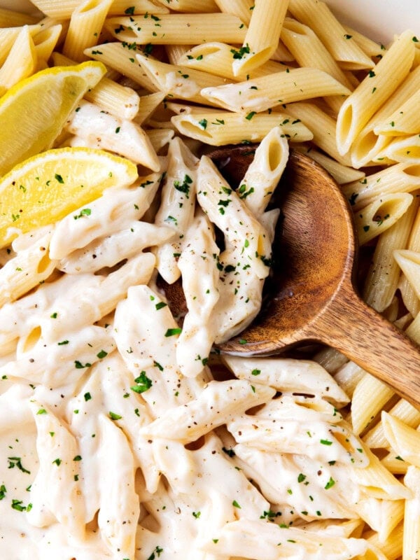 Scooping up Alfredo Penne Pasta loaded with bouncy pasta and lots of homemade Alfredo sauce