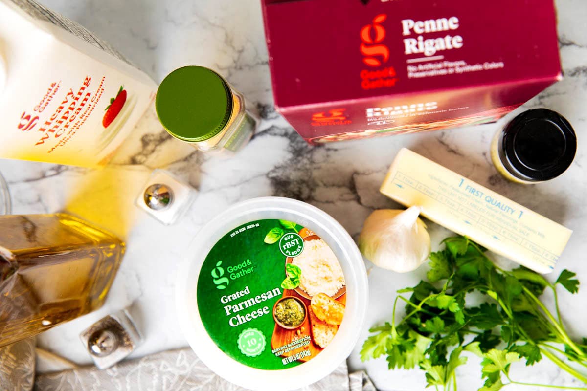 Alfredo with penne pasta ingredients include penne rigate pasta, butter, Parmesan cheese, heavy cream, olive oil, garlic powder, and salt and pepper.