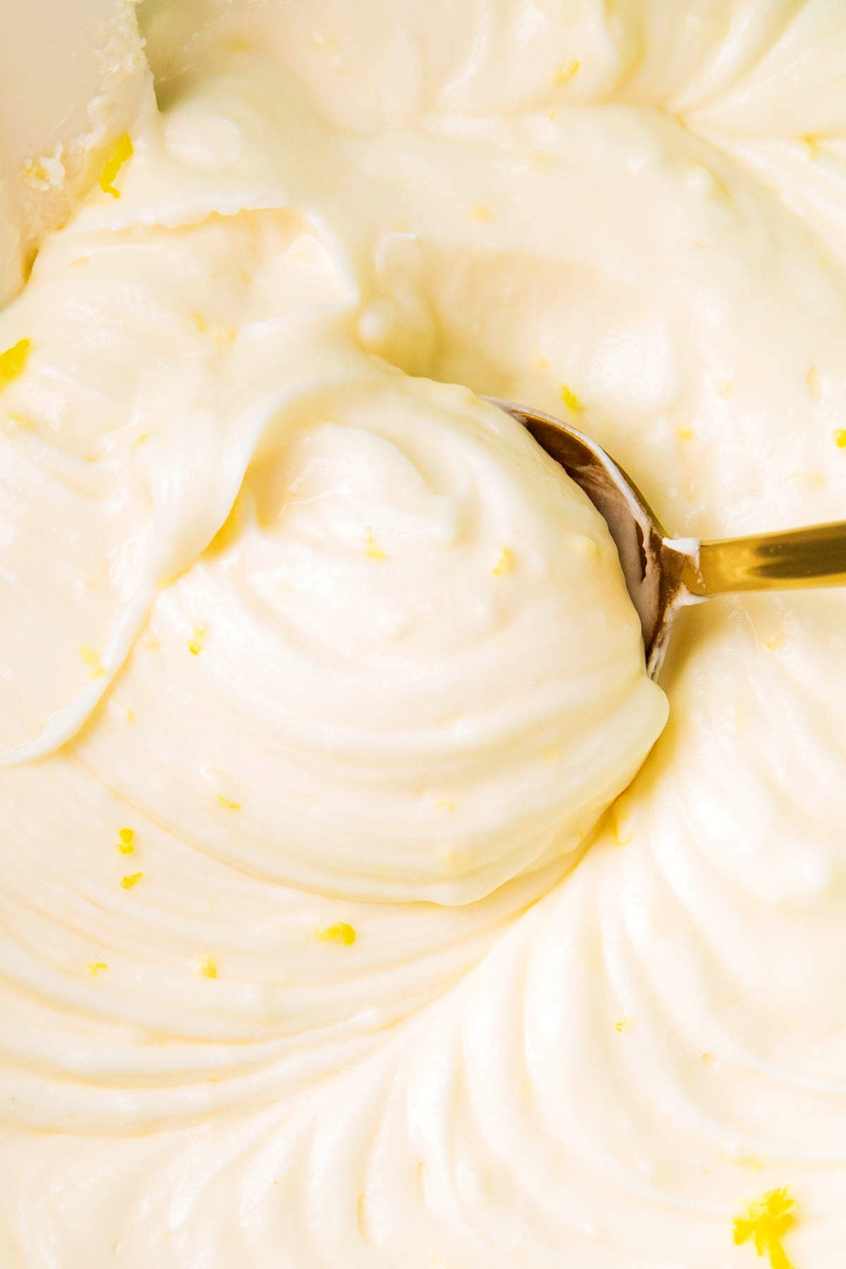 Close up of this cream cheese lemon frosting recipe with fluffy smooth texture.