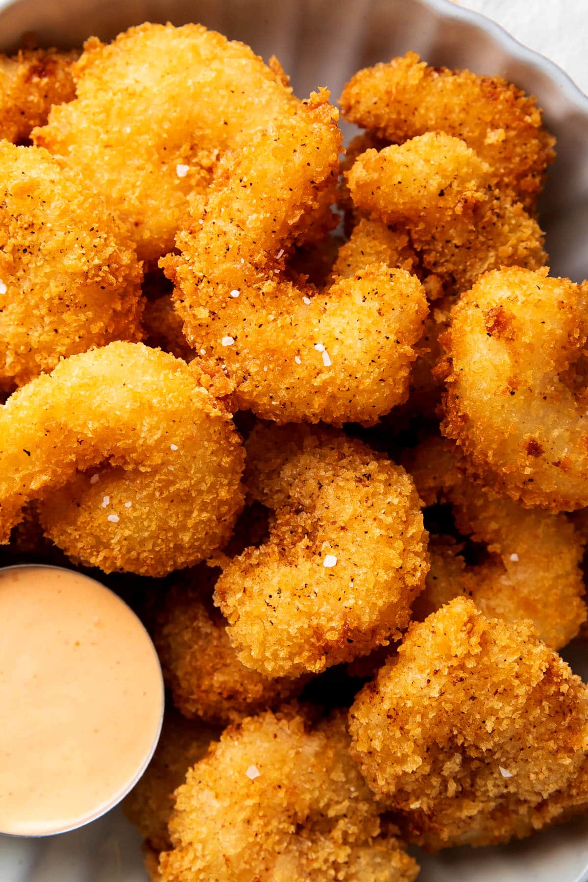 Crispy shrimp recipe is shown with fried, golden bread crumb coating.