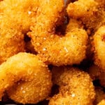 Fried crispy shrimp is coated in an easy bread crumb exterior that's crunchy and served with sauce