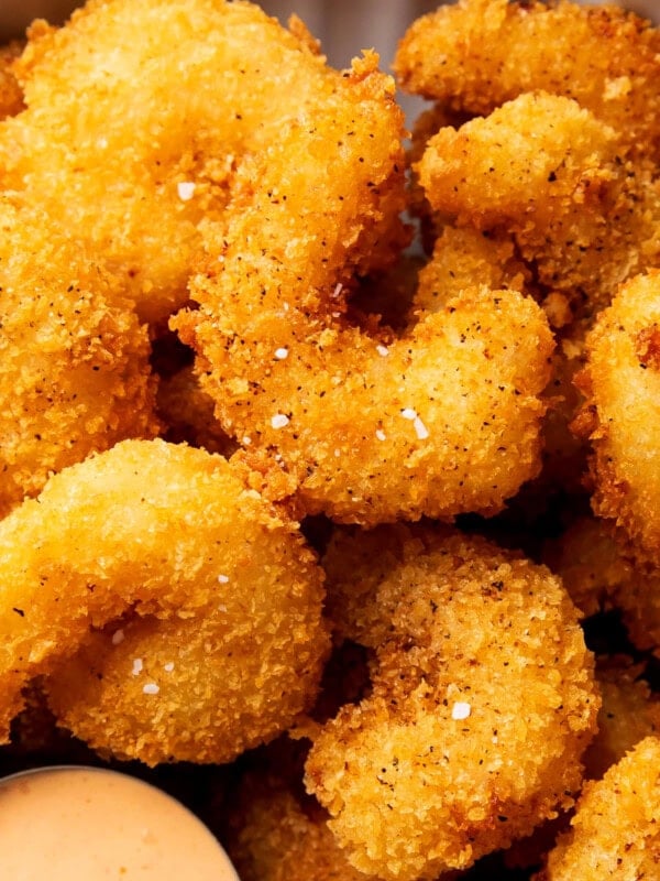 Fried crispy shrimp is coated in an easy bread crumb exterior that's crunchy and served with sauce