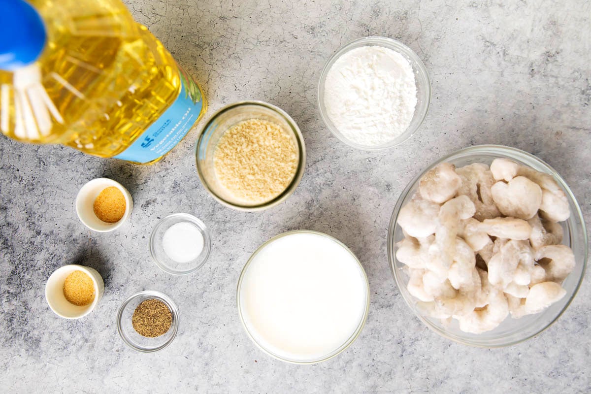 Easy fried shrimp recipe ingredients - frozen shrimp, oil, Panko bread crumbs, cornstarch, buttermilk, and seasonings.