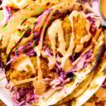 Panko shrimp tacos stuffed with crispy fried shrimp, cilantro lime slaw, and spicy mayo wrapped in fire grilled tortillas