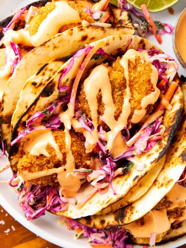 Panko shrimp tacos stuffed with crispy fried shrimp, cilantro lime slaw, and spicy mayo wrapped in fire grilled tortillas