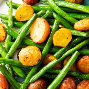 Roasted potatoes and green beans recipe with tender roasted red potatoes and crisp roasted green beans served on a plate