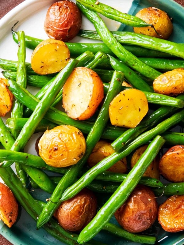 Roasted potatoes and green beans recipe with tender roasted red potatoes and crisp roasted green beans served on a plate